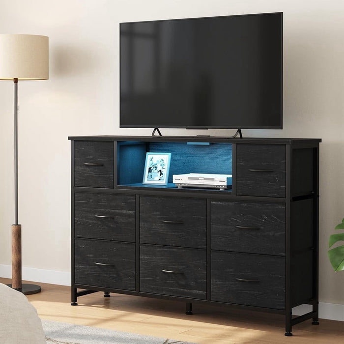 Nextay LED TV Stand with Charging Station, Music-Sync Light Up Entertainment Center, 8 Fabric Drawer Dresser for Bedroom & Living Room, Black Wood(Fits 45-55 inch TV)
